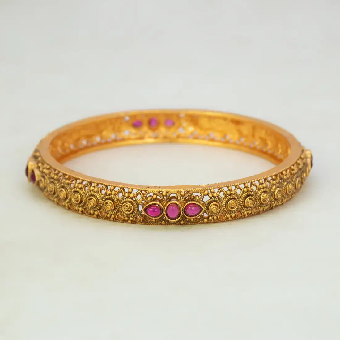 Antique Gold Plated Kemp Stone Kada Bangle with ruby red Kemp stones and intricate detailing.