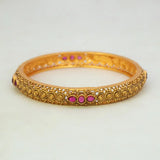 Antique Gold Plated Kemp Stone Kada Bangle with ruby red Kemp stones and intricate detailing.