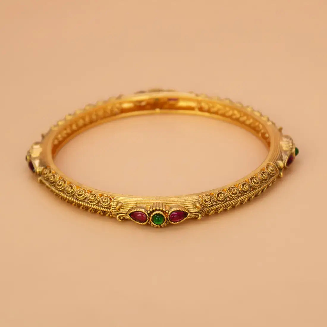 Antique Matte Kemp Multi Colour Stone Bangle showcasing intricate gold design with ruby red and emerald green stones.