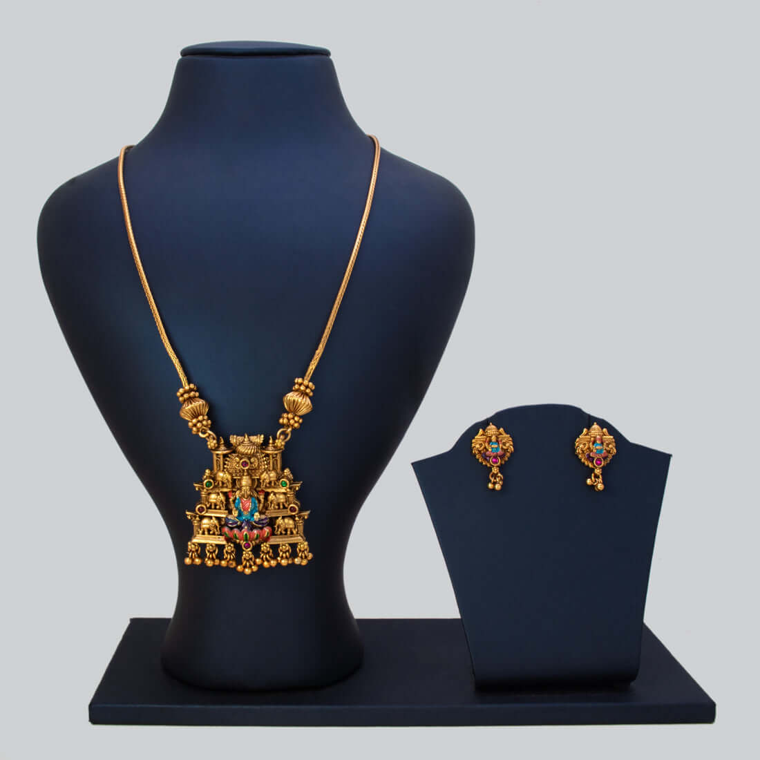 Antique Lakshmi Elephant Temple Pendant Necklace Set displayed on a bust with matching earrings.