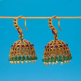 Antique Gold Ruby Red Kemp Stone Jhumka Earrings featuring ruby and green stones with intricate gold detailing.