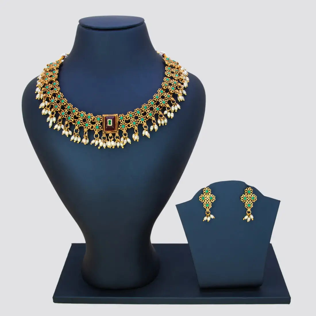 Antique White Pearls Hanging Stone Necklace Set with matching earrings displayed on a stand.