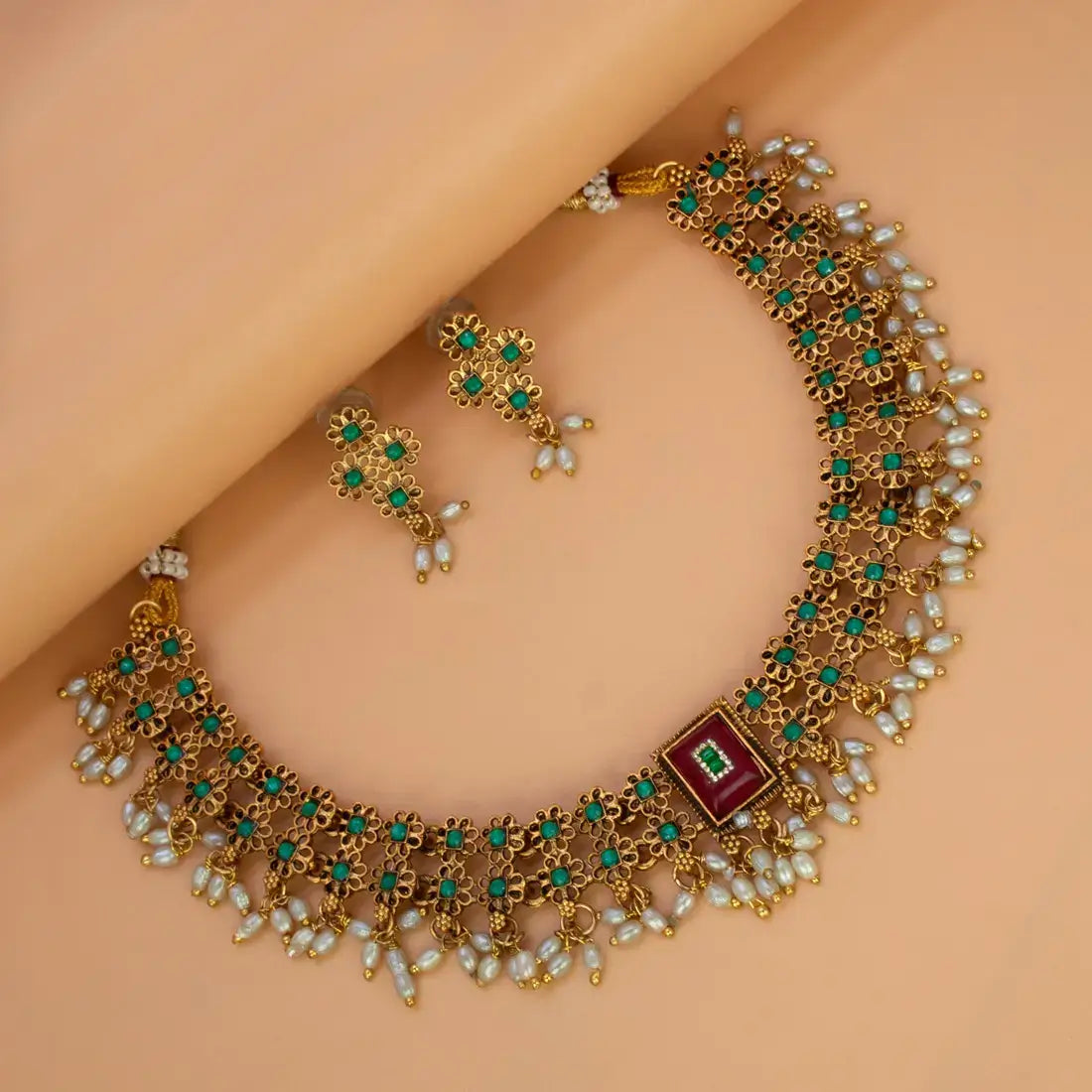 Antique White Pearls Hanging Stone Necklace Set featuring filigree work, matching earrings, and vibrant stone details.