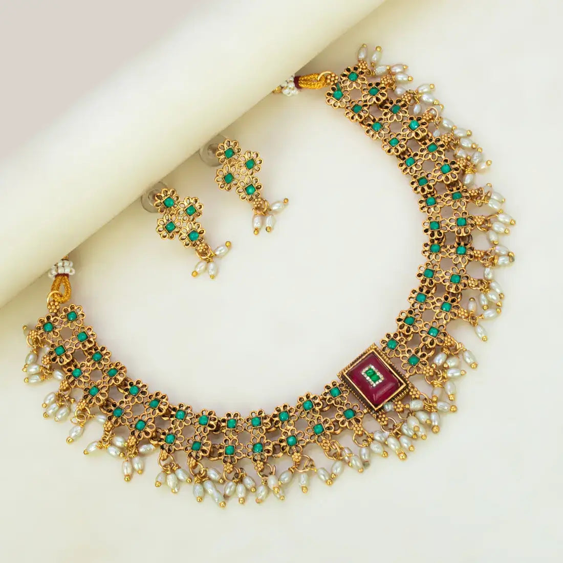 Antique White Pearls Hanging Stone Necklace Set featuring ornate gold details and matching earrings.