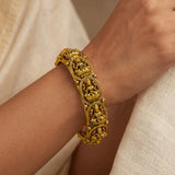 Antique Gold Plated Lakshmi Kada Bangle showcased on a hand, featuring intricate Goddess Lakshmi designs.