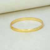 Kada-Style Gold Plated Bangle for Baby Boys resting on a soft surface, showcasing its elegant design.