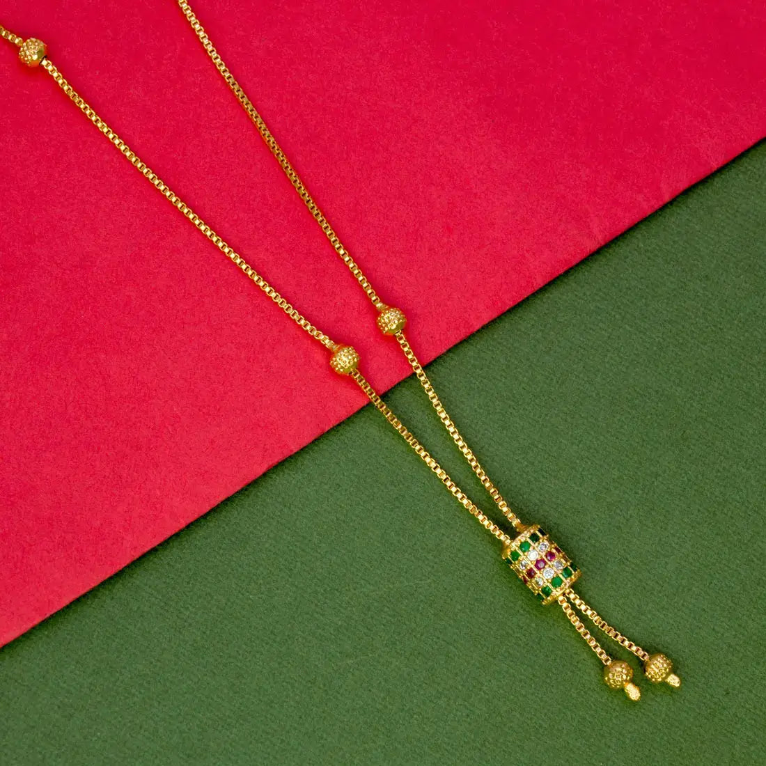 Elegant Gold Plated Cylindrical Stone Pendant Chain displayed on a colorful background.
