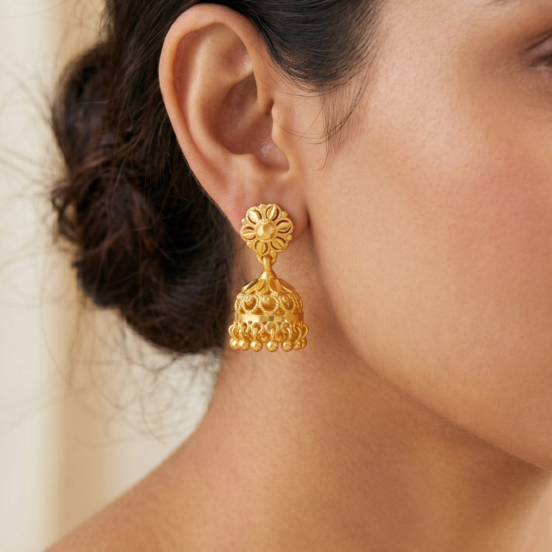 Gold-Plated Small Floral Jhumka earrings showcased on a woman, highlighting traditional Indian craftsmanship.