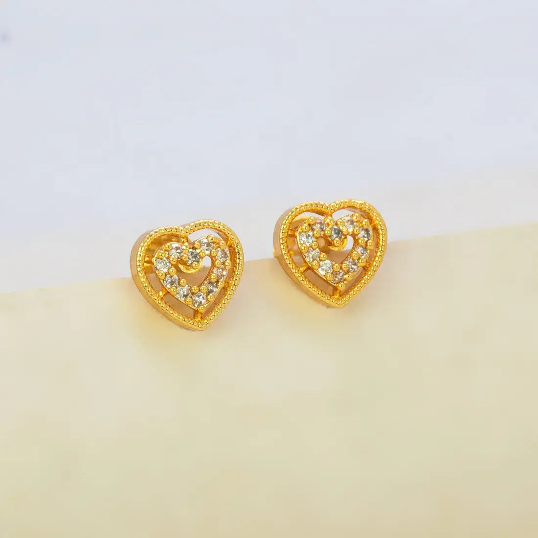 Gold Heart Design Stone Stud Earrings showcasing intricate heart shapes with sparkling stones.
