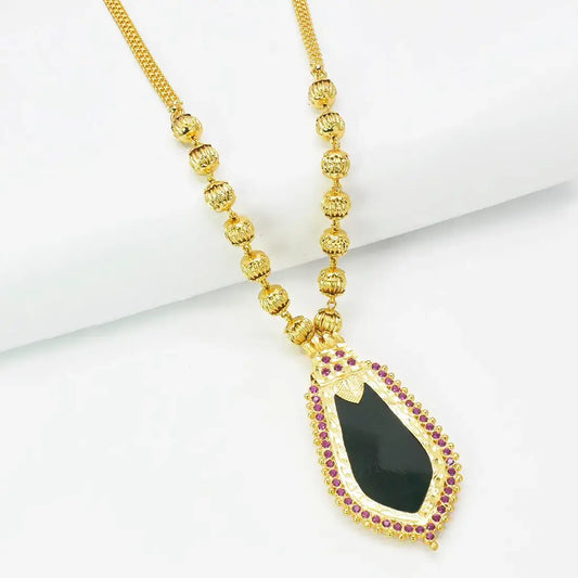 Premium Gold Plated Ball Necklace With Nagapadam Pendant featuring a black stone centerpiece and ruby accents.