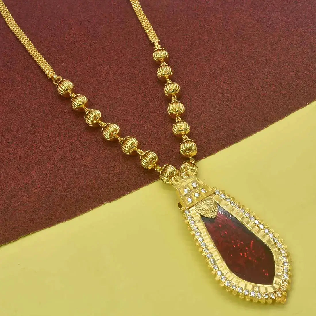 Premium Gold Plated Ball Necklace With Nagapadam Pendant highlighting a striking red gemstone and intricate design.