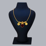 Green Enamel Gold Plated Lakshmi Kasu Necklace with ruby stone and Lakshmi coins on a display bust.