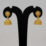 Gold-plated earrings on a black earring stand against a gray background