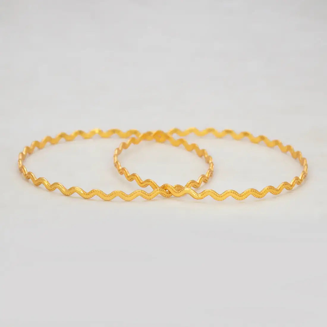 Unique Gold Plated Zigzag Bangles showcasing a bold, undulating design with micro-bead texture.