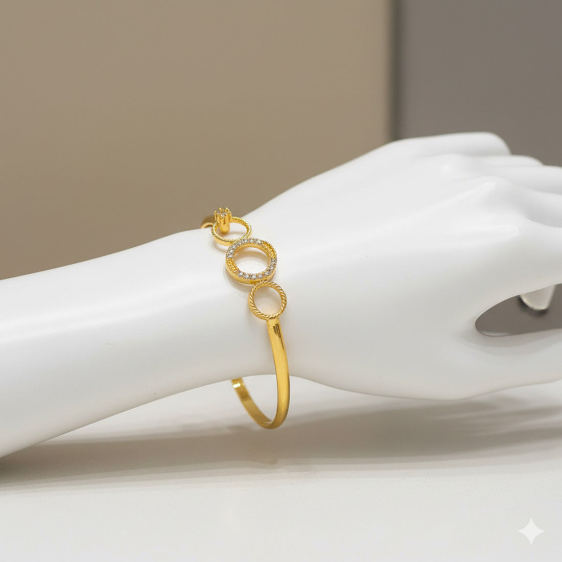 Trendy Premium American Diamond Open Bangle displayed on a hand, featuring gold plating and interlinked circles.