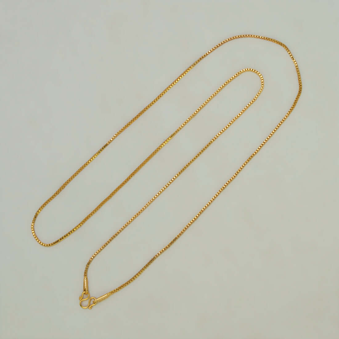 Aesthetic Gold Plated Thin Box Chain For Women on a neutral background, highlighting its delicate and sleek design.