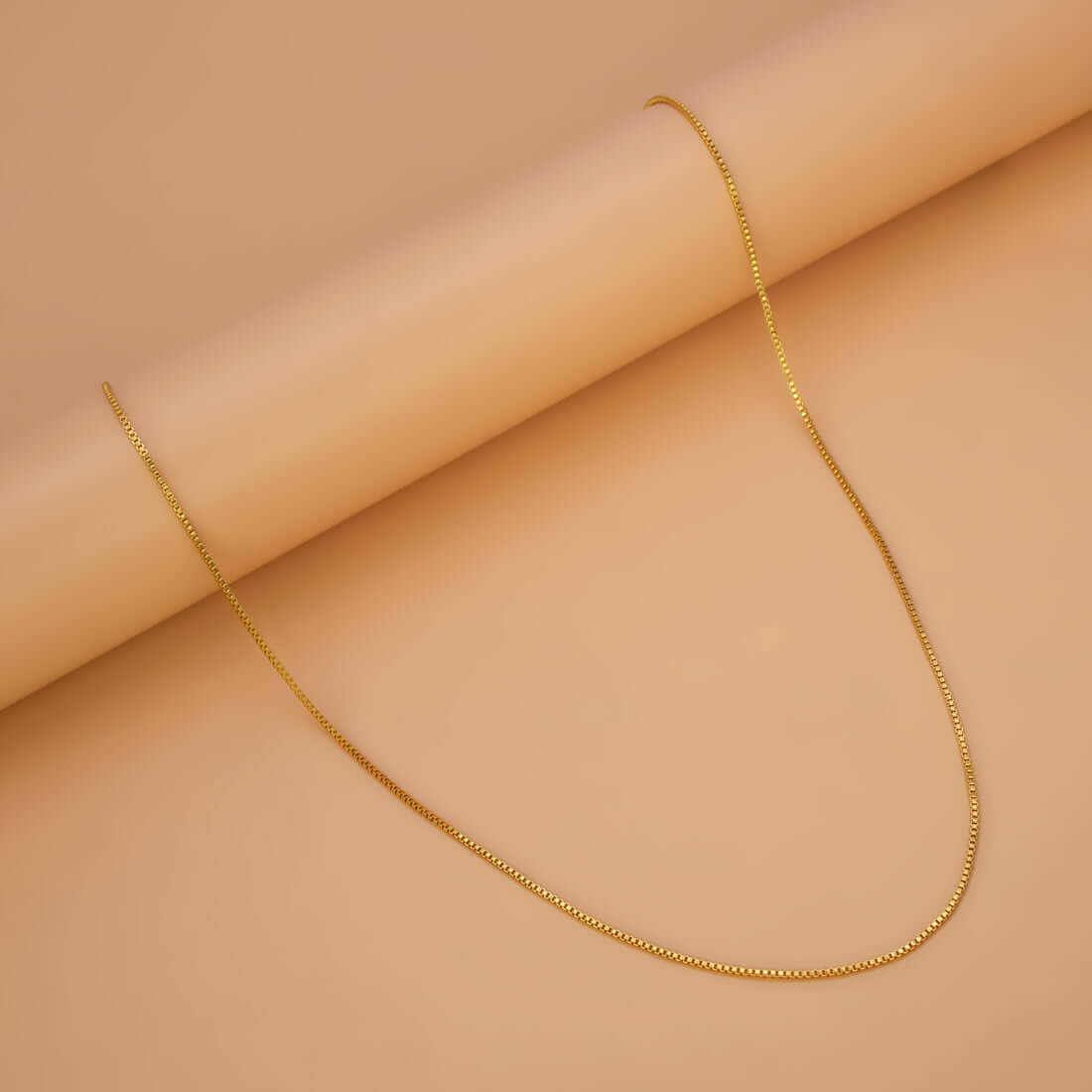 Gold Plated Nice Kilukkam Box Chain - 18" elegantly displayed on a textured surface.