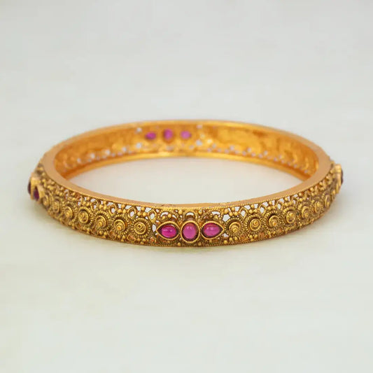 Antique Gold Plated Kemp Stone Kada Bangle with ruby red Kemp stones and intricate detailing.