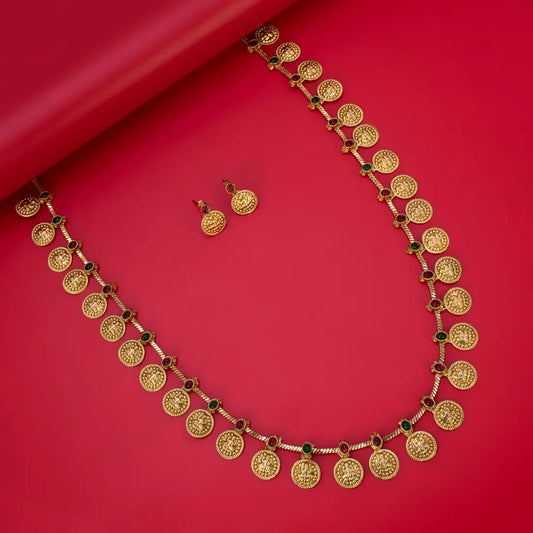 Traditional Antique Lakshmi Kasu Kemp Long Chain Set with gold goddess coins and Kemp stones on a red background.