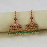 Antique Gold Ruby Red Kemp Stone Jhumka Earrings with green crystals and intricate detailing.