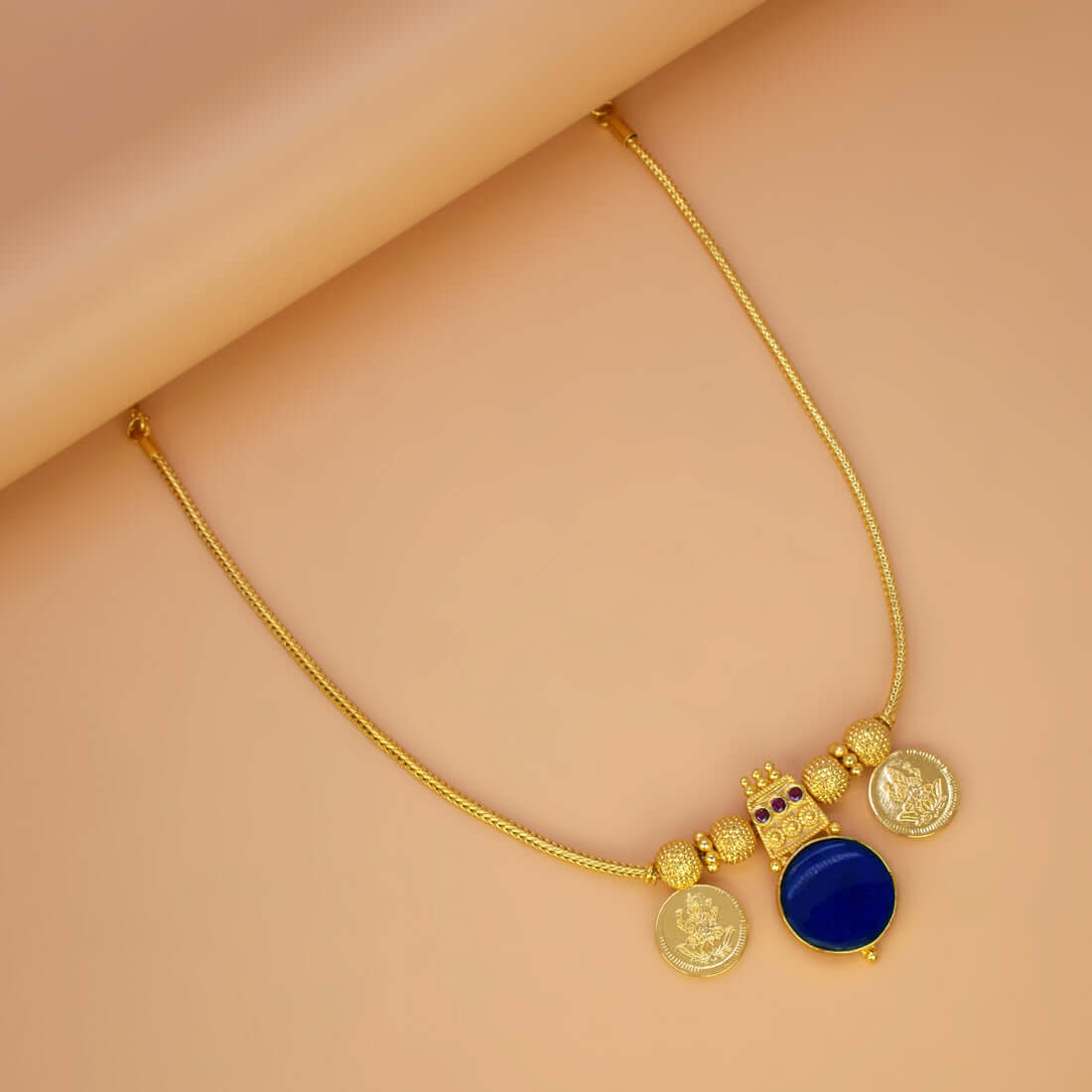 Green Enamel Gold Plated Lakshmi Kasu Necklace featuring gold coins and a blue stone pendant.