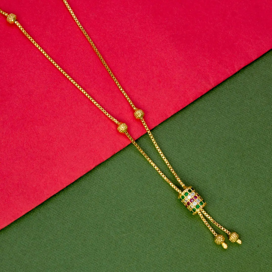 Elegant Gold Plated Cylindrical Stone Pendant Chain displayed on a colorful background.