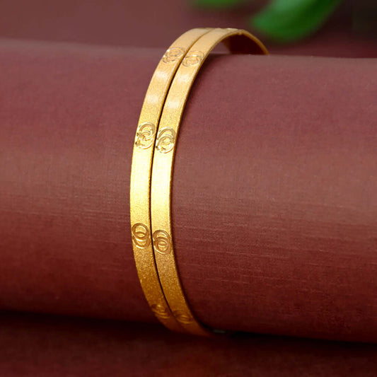 Elegant Matte Gold Plated Designer Bangles on a display surface, showcasing their smooth finish and elegance.