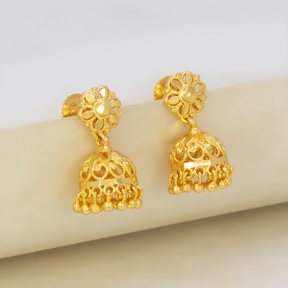 Gold-Plated Small Floral Jhumka Earrings with filigree design and bell drop, adorned with delicate beads.