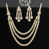 Gold necklace and earrings set on a black background with 'Style Club' branding.