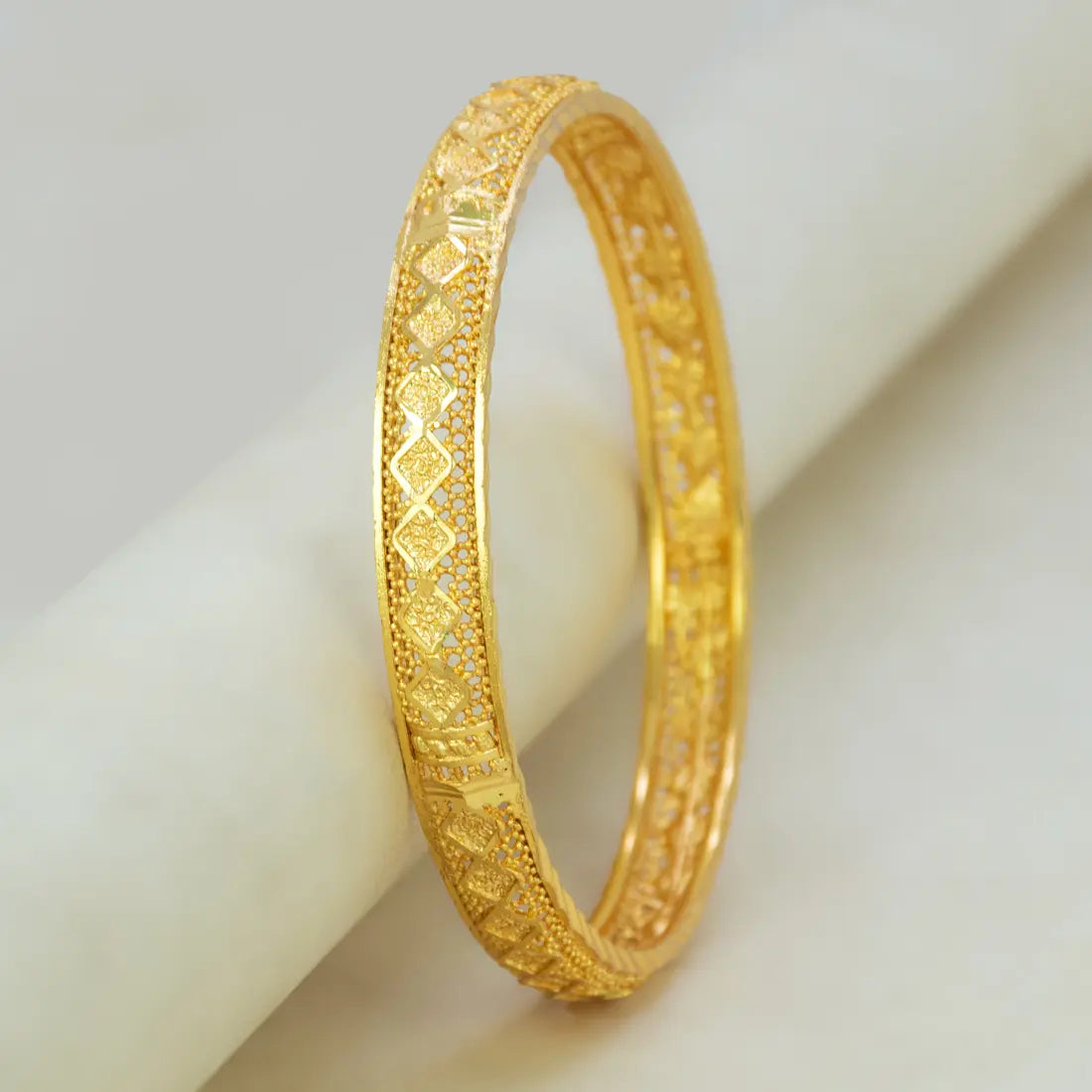 Gold Plated Mesh Diamond Design Net Bangle showcasing intricate diamond-cut detailing on a gold-plated surface.