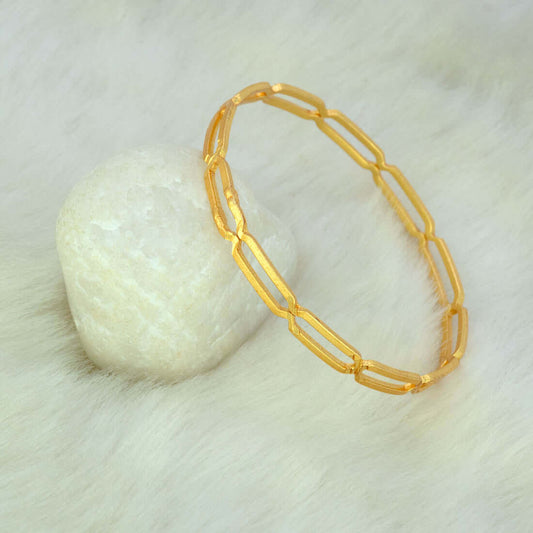 Elegant Gold Plated Link Design Plain Bangle resting on a white surface, showcasing its trendy design and shine.