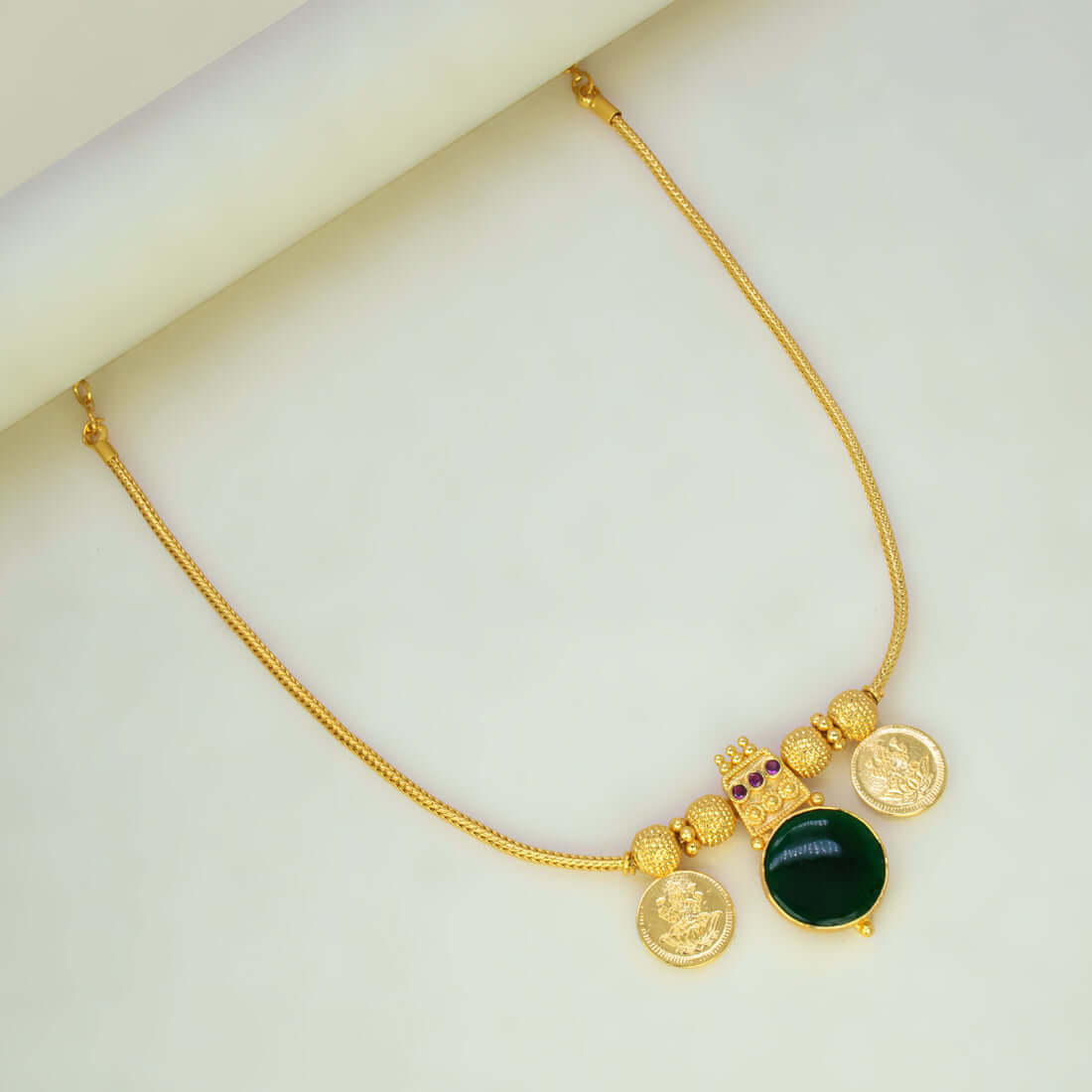 Green Enamel Gold Plated Lakshmi Kasu Necklace featuring emerald stones and traditional Lakshmi coins.