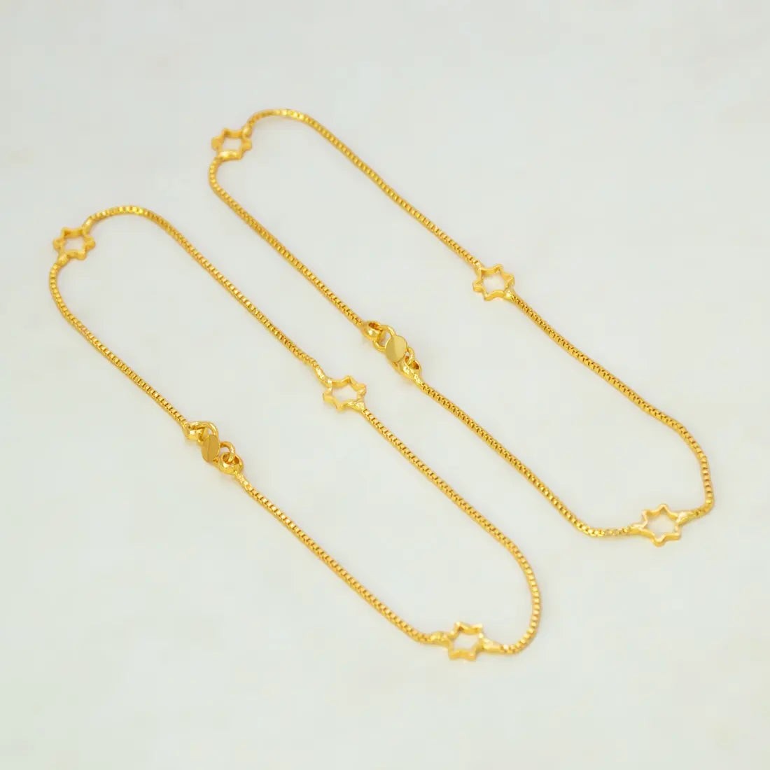 Delicate Gold Plated Star Box Chain Anklets featuring open star charms on a fine gold chain.