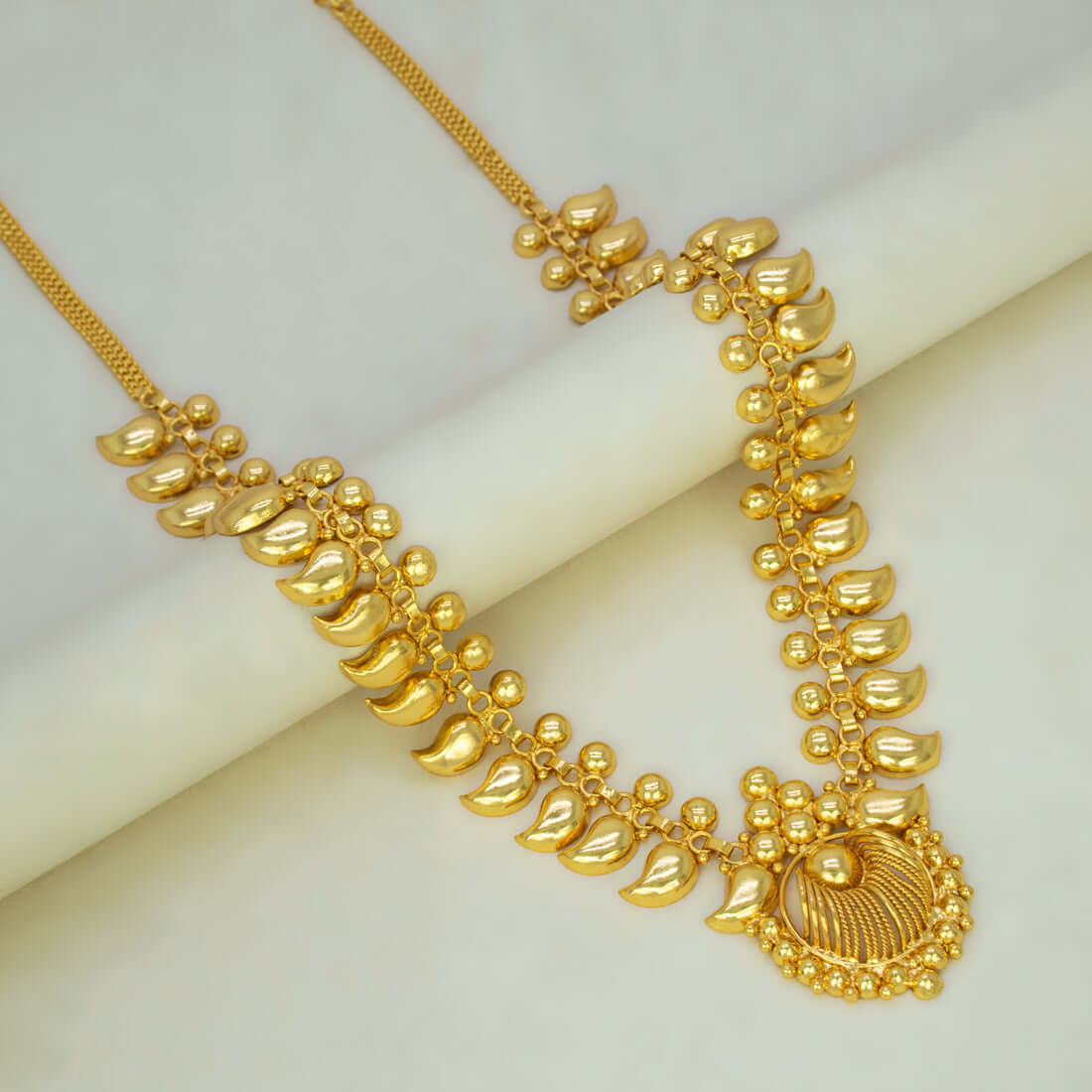 Traditional Gold Plated Bridal Mango Long Chain Haram displayed elegantly on a white surface.