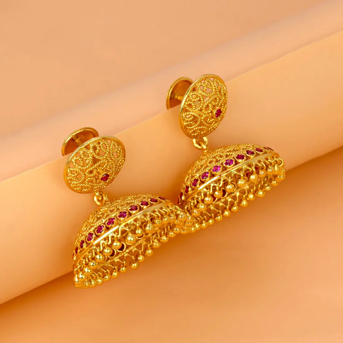 Premium Gold Plated Filigree Ruby Stone Umbrella Jhumka earrings with intricate designs and ruby accents.