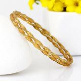 Elegant Gold Plated Designer Spiral Bangles showcasing a twisted spiral design, perfect for daily wear and versatile styling.