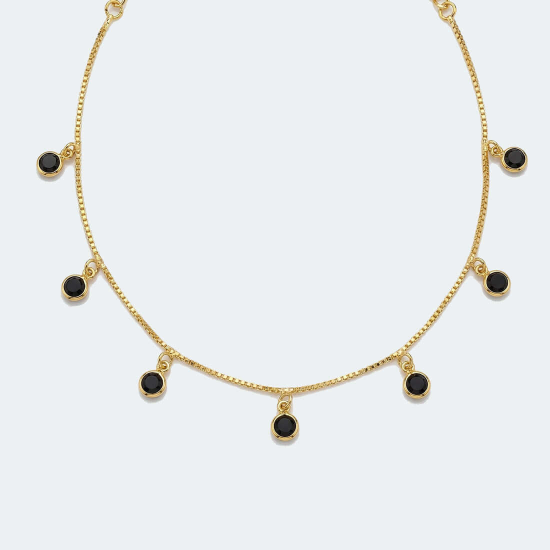 Gold-plated necklace with small black stone pendants