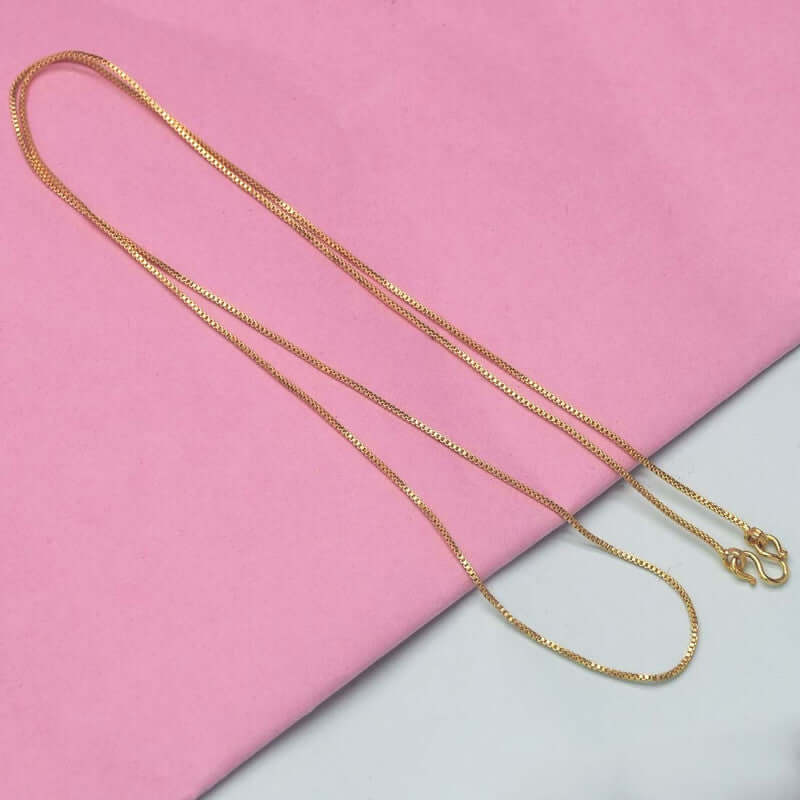 Very Nice Designer Ladies Kilukkam Box Chain displayed on pink background, showcasing the elegant gold plated chains.